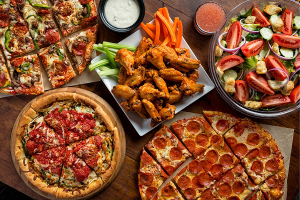 Pizza, wings and salad at Uno Pizzeria & Grill